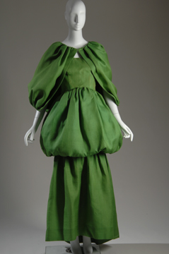 mannequin in a green floor-length tiered dress with matching cape