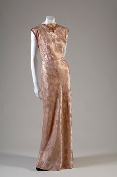 mannequin in a floor-length gold satin dress